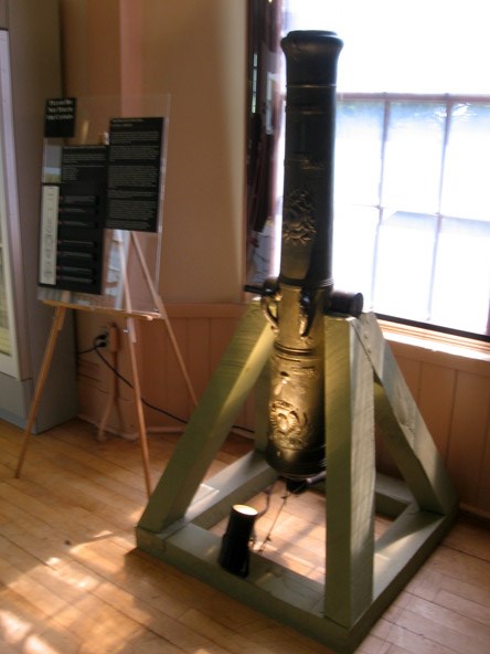 In use, this French field gun would be mounted on a wheeled carriage. It is displayed vertically to view the ornate markings.