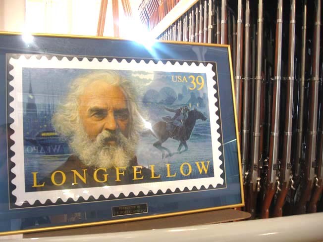 Image of Longfellow postage stamp next to the musket rack