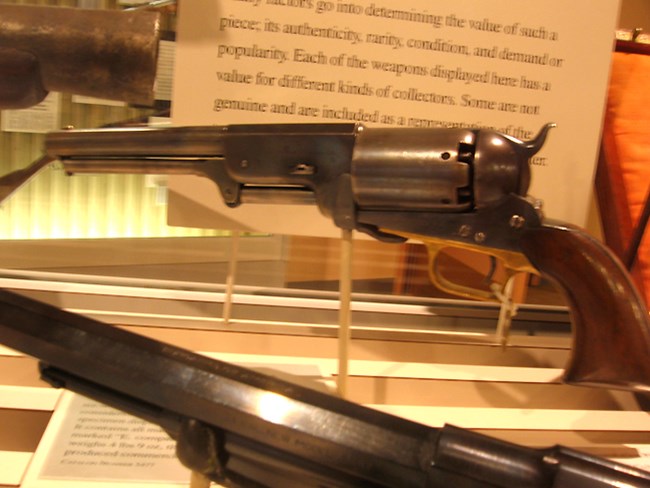 Colt Walker revolver in the background