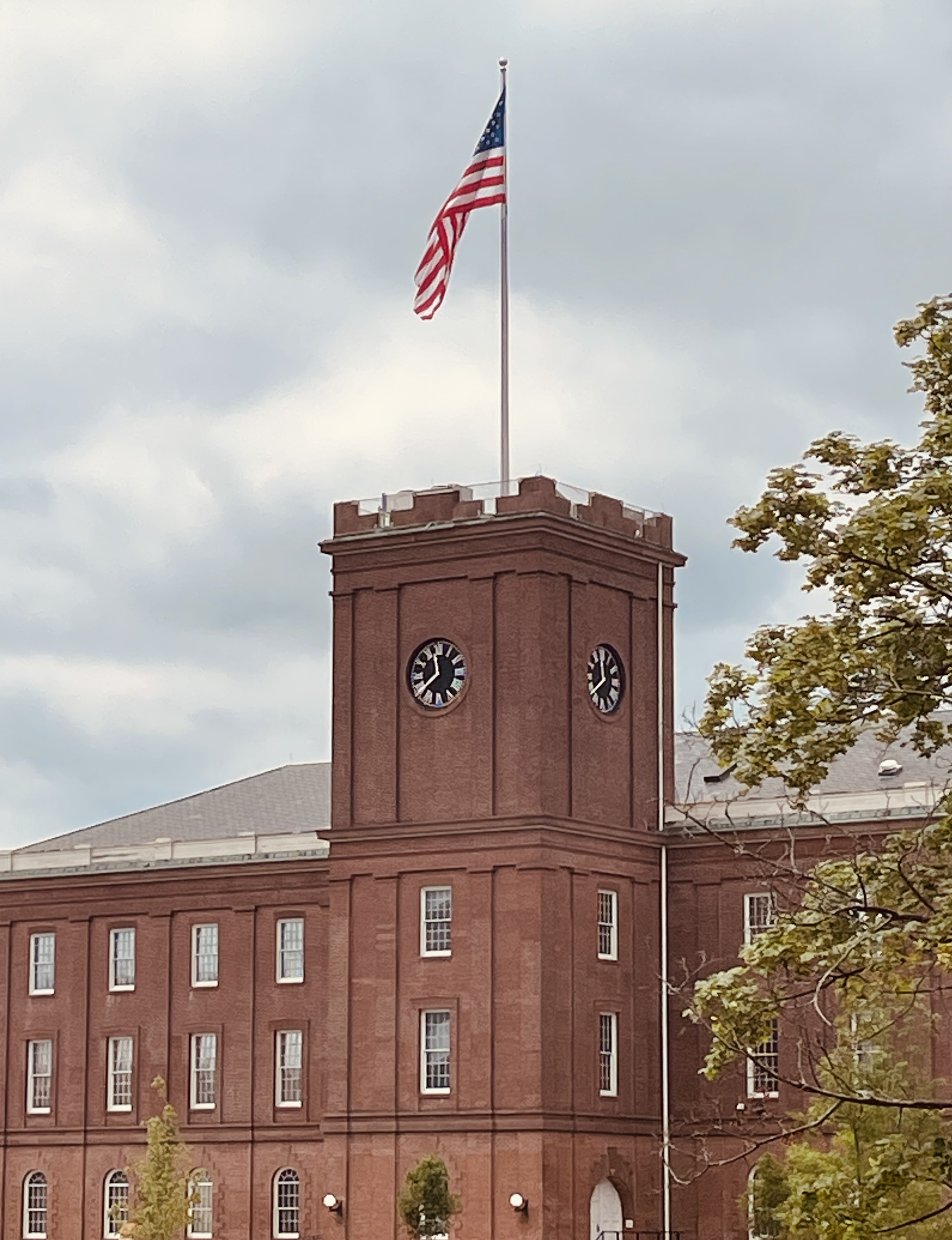 Armory Clock Tower Red brick building with clock tower showing two clock faces at 11:39 am.