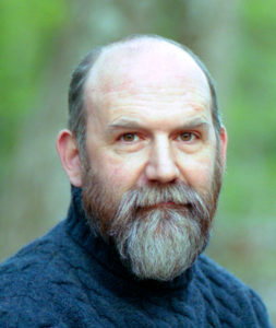 Dan Bullen Head shot of a man with a gray beard in a blue cable knit sweater