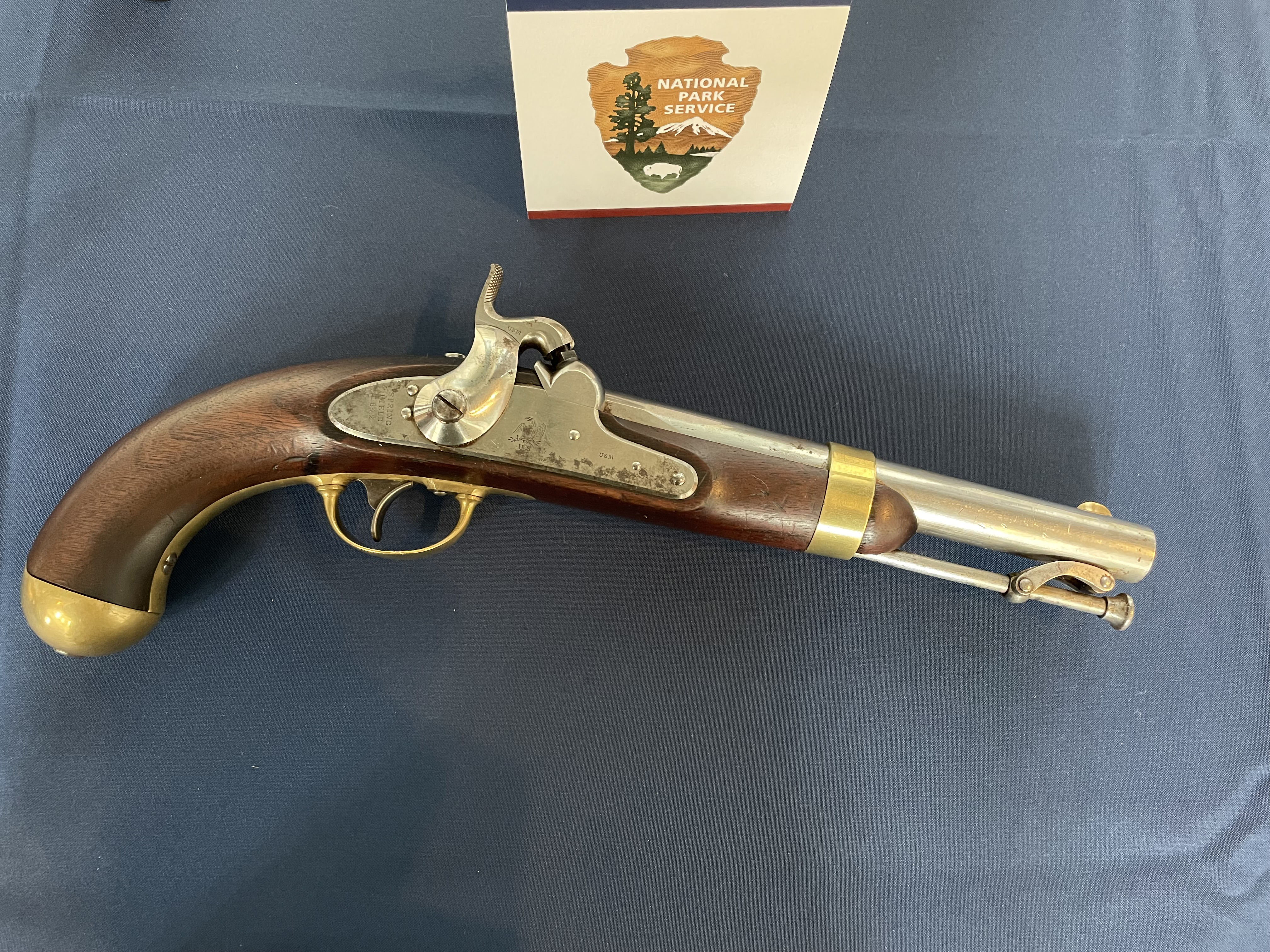 A wooden handled-pistol with brass fittings, 19th century