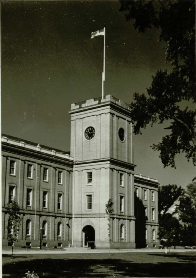 The Main Arsenal Clocktower, with a flag high atop waving in the wind.