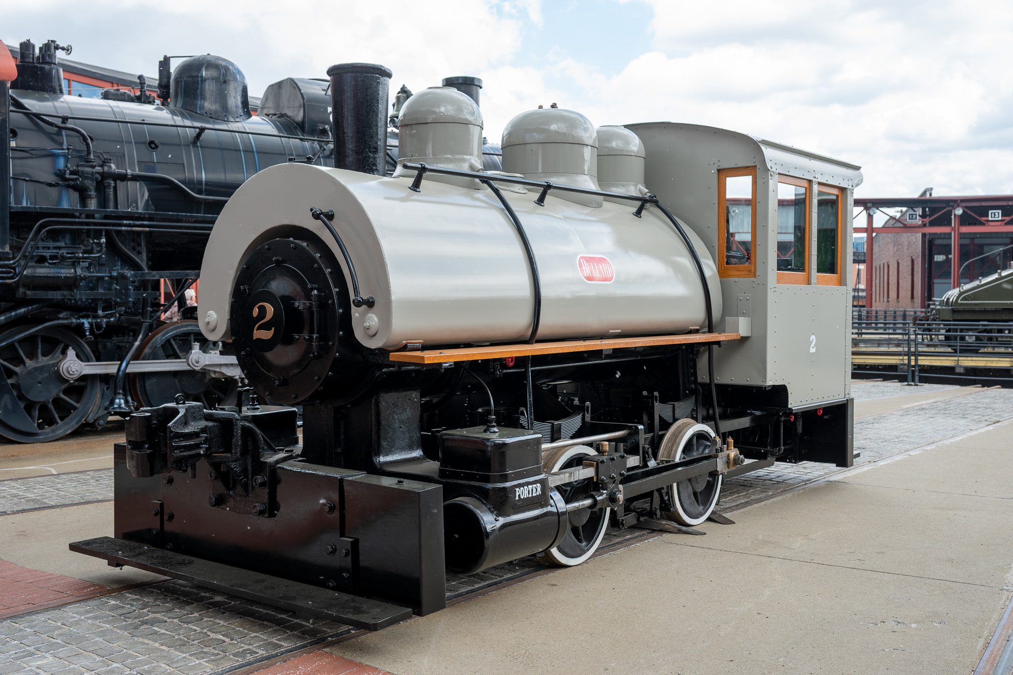 Small black and gray locomotive parked outdoors