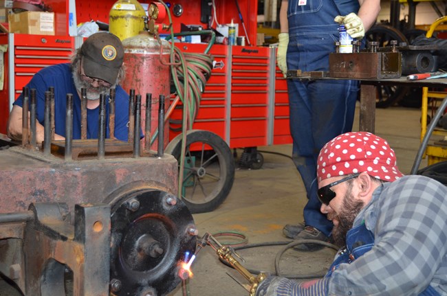 Two volunteers work on locomotive
