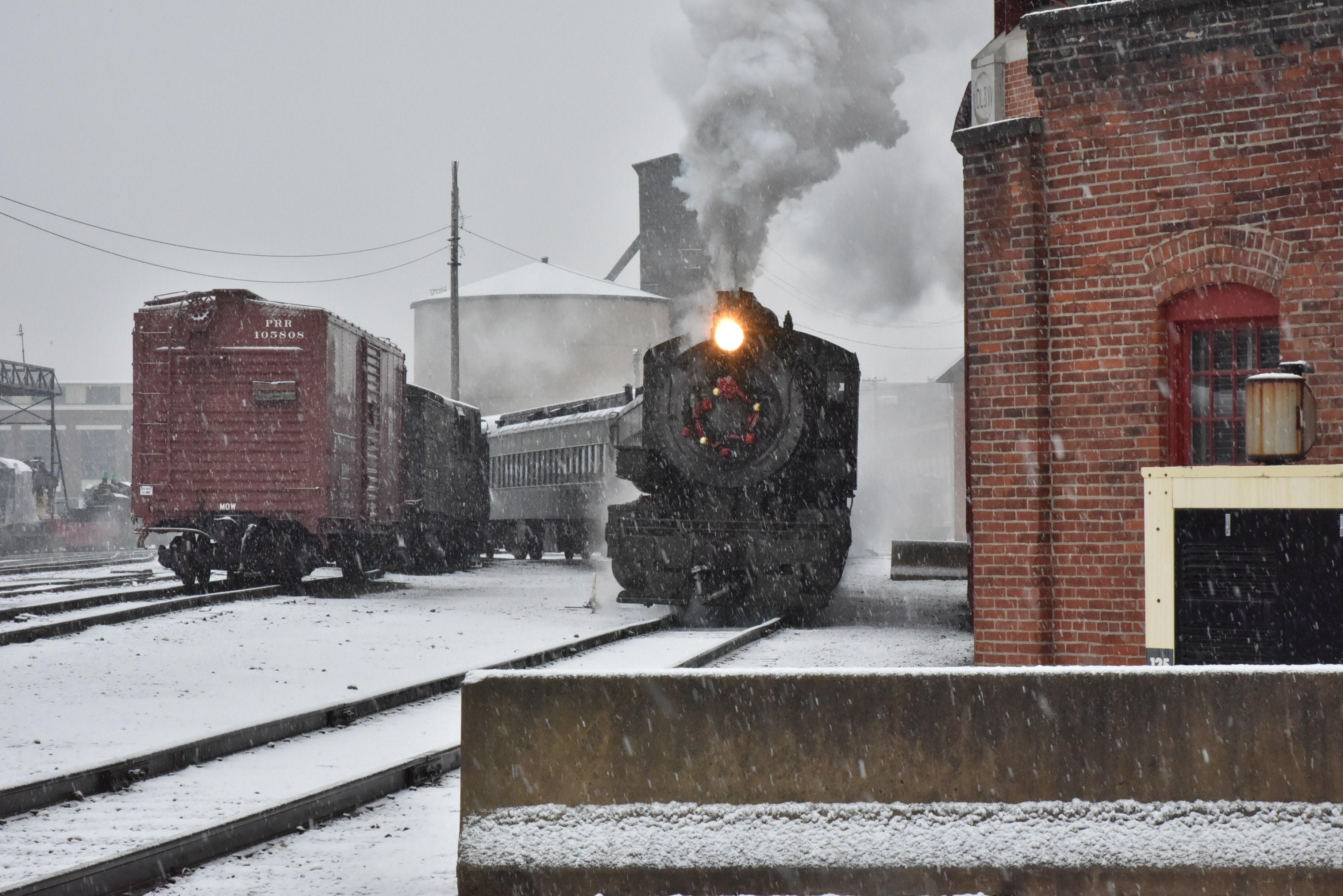 Baldwin Locomotive Works #26 steam engine chugs along on a snowy day at Steamtown NHS