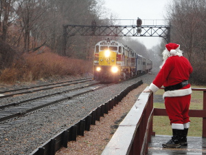 Santa waits along a wooden train platform at Moscow Station for arriving Steamtown NHS "Holiday Express" train