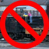 Two children unsafely climb on an historic freight car, with a circle and slash laid over the picture. Please to not climb. Two children unsafely climb on an historic freight car, with a circle and slash laid over the picture. Please to not climb.