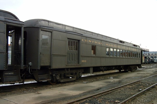 Central Railroad of New Jersey Combine Car #303, painted in dark green paint with railroad name and car ID in gold lettering Central Railroad of New Jersey Combine Car #303, painted in dark green paint with railroad name and car ID in gold lettering