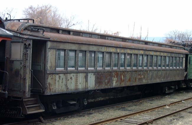 Delaware, Lackawanna & Western Railroad Electric Passenger Trailer #320, rusting, formerly painted in dark green paint and with yellow lettering for Erie Lackawanna Delaware, Lackawanna & Western Railroad Electric Passenger Trailer #320, rusting, formerly painted in dark green paint and with yellow lettering for Erie Lackawanna