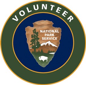 Circular logo reading Volunteer with the National Park Service arrowhead at the center