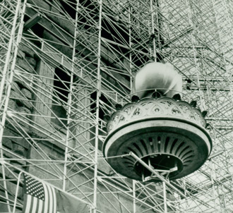 The new torch being lifted into place during restoration circa 1985.