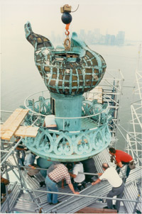 A photograph depicting the preparation for torches removal during restoration circa 1984.