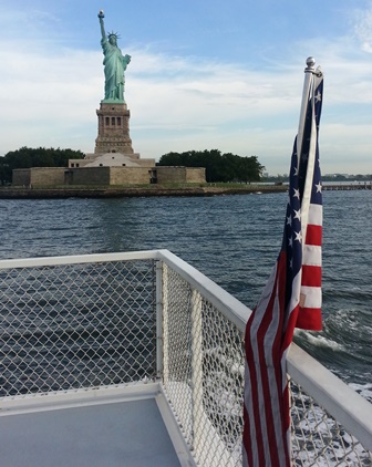 Statue of Liberty with American flag from boat. Statue of Liberty with American flag from boat.