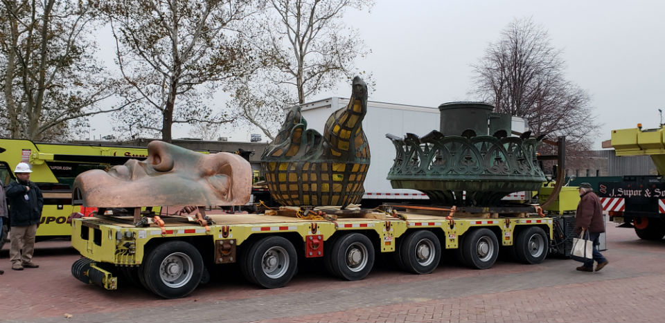 The original torch on top of a remote controlled, auto-leveling hydraulic transporter ready for a trip across Liberty island to its new home in the Statue of Liberty Museum