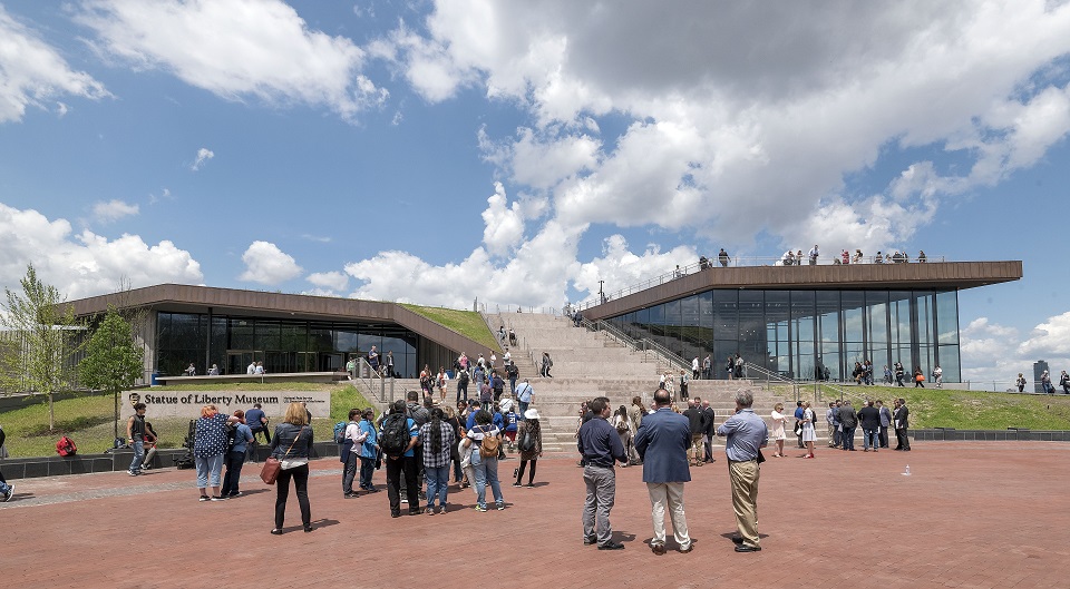 The new museum from outside on opening day. People gathered on and around the museum on Liberty Island.