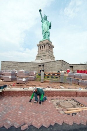 Worker rebuilds walkway on Liberty Island in preparation for the reopening of the Statue of Liberty on July 4, 2013. NPS photo by Kevin Daley. Worker rebuilds walkway on Liberty Island in preparation for the reopening of the Statue of Liberty on July 4, 2013. NPS photo by Kevin Daley.