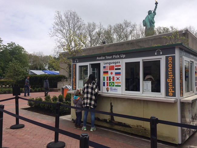 Visitors picking up audio-guides at the booth located on Liberty Island