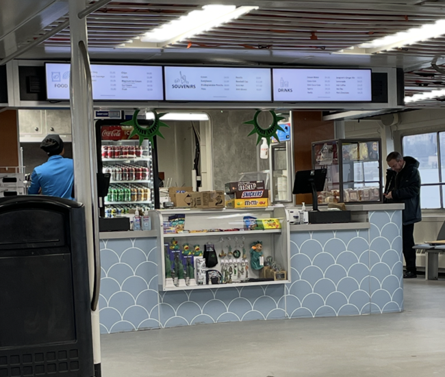 Statue City Cruises concessions, a photo of a counter with souviniers, snacks and drinks on the boat.