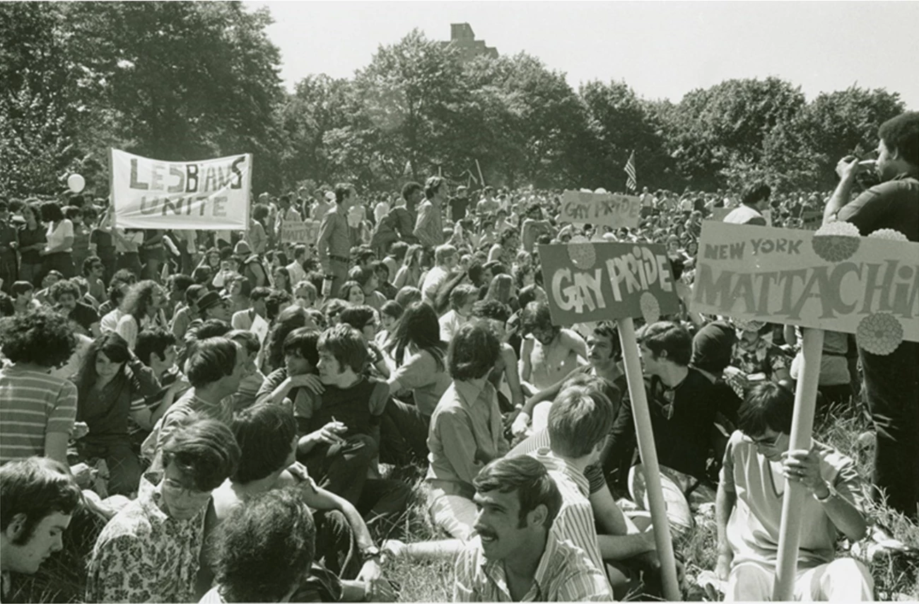 Gay ‘Be-In” at Sheep Meadow, Central Park, 1970. Thousands of people sitting in the park with signs read “lesbians unite,” “gay pride,” and “New York Mattachine.”