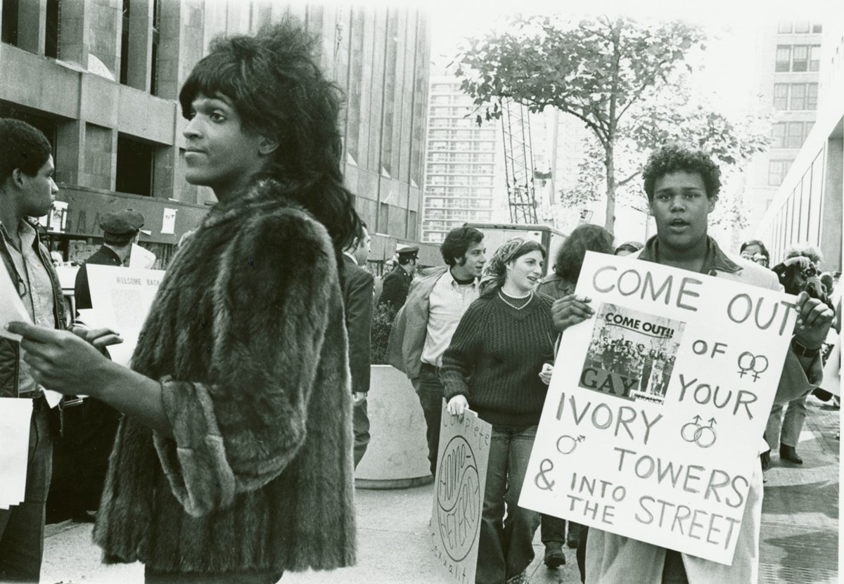Marsha P. Johnson handing out flyers with NYC students in the background