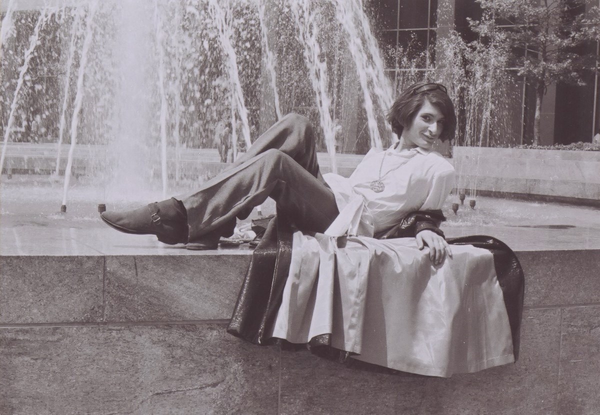 Sylvia Rivera at age 18 laying back and posing on the edge of a water fountain