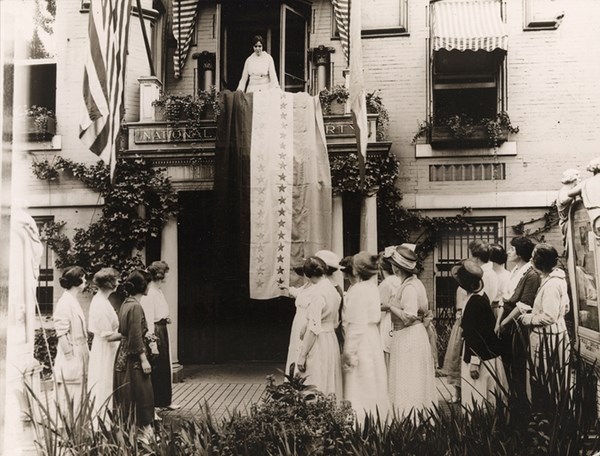 Suffragist Alice Paul unfurling the ratification flag after Tennessee ratified the 19th Amendment.