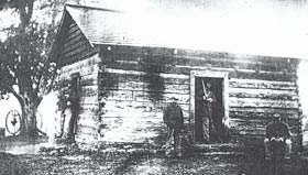 African American soldiers seated and standing in front of a cabin. African American soldiers seated and standing in front of a cabin.