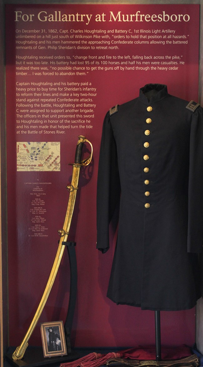 Exhibit showing Houghtaling's frock coat, engraved saber, sash, and belt.
