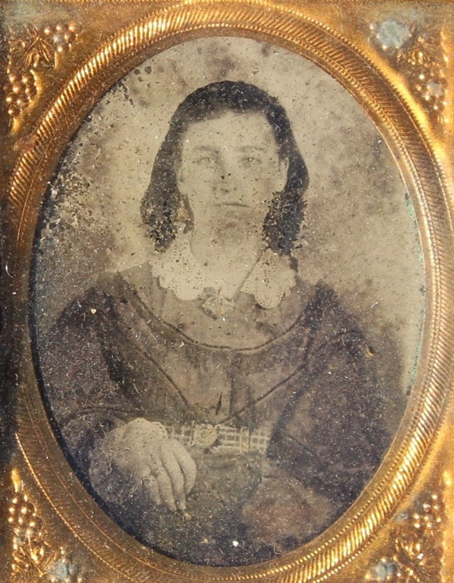 Tintype image of Kate Miller with gold frame.