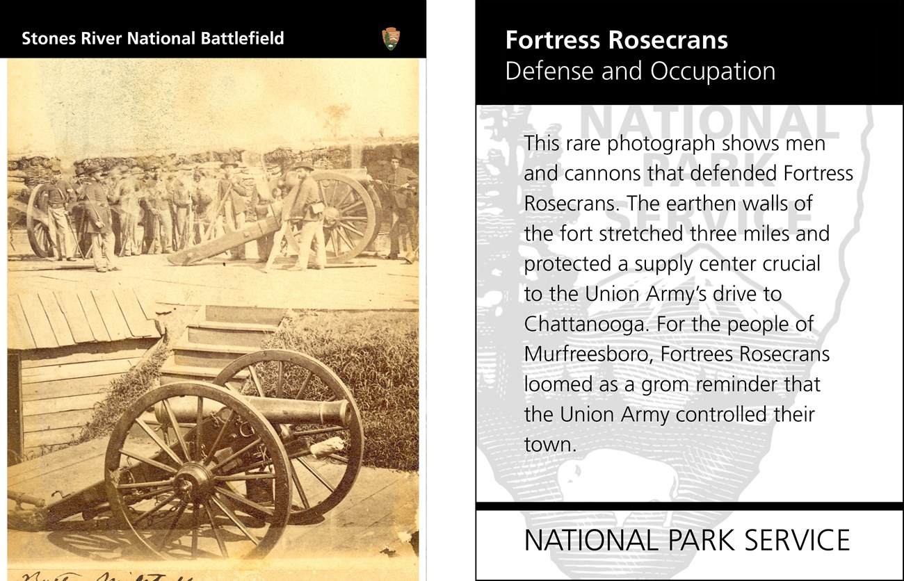 A black and white photo of a cannon on a wooden platform, with soldiers and another cannon on a platform above it in the background. Text  is on the reverse side of the card.