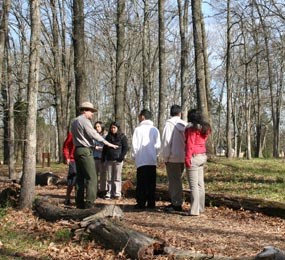 A ranger talks to kids on a trail. A ranger talks to kids on a trail.
