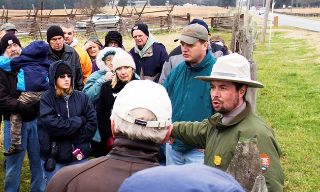 A park ranger speaks in front of a crowd
