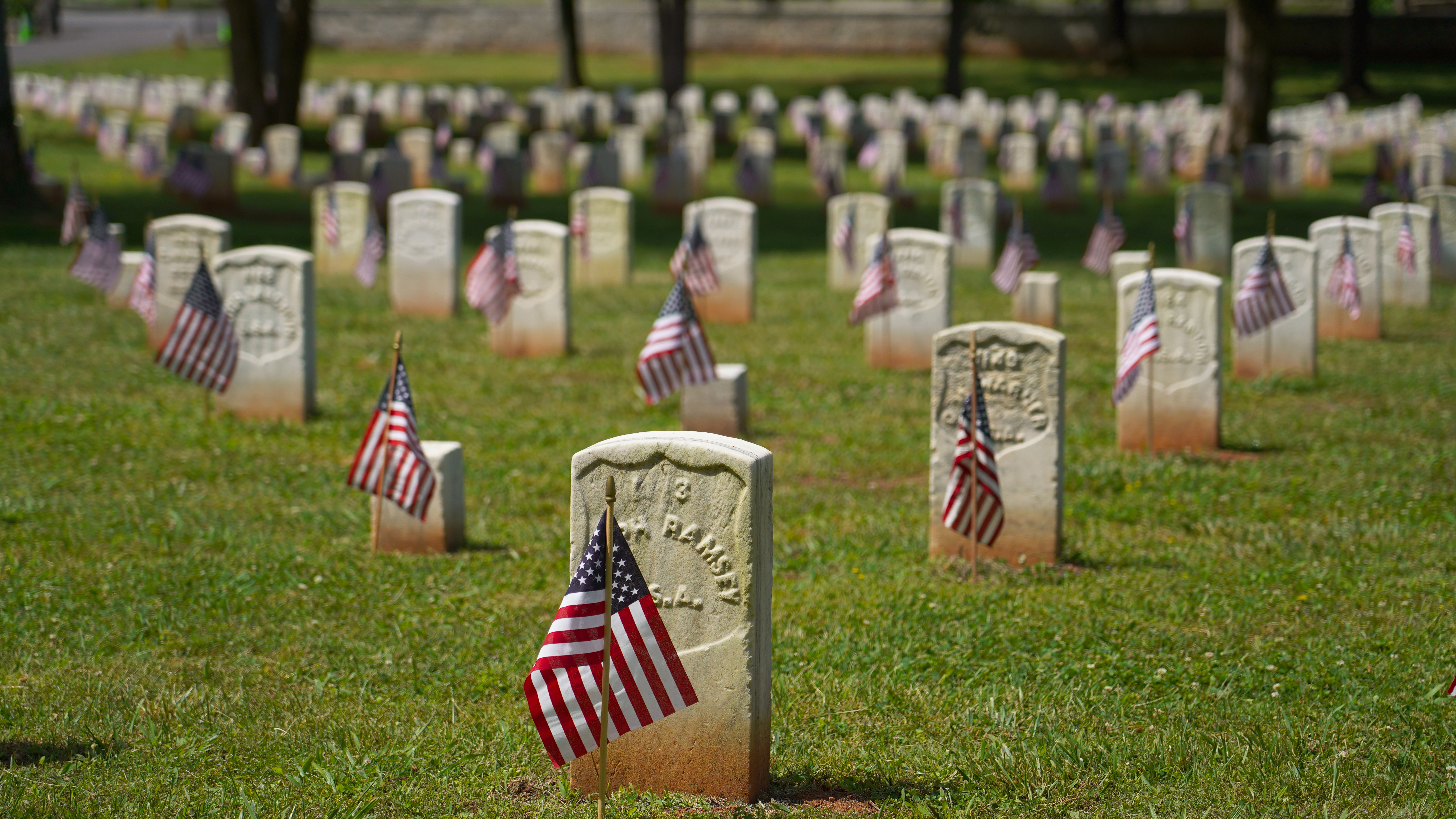 Shawn Anfinson SRNB_7 American flags adorn rows of white headstones.