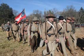 Confederate soldiers march while carrying a first national flag. Confederate soldiers march while carrying a first national flag.