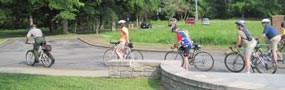 A park rangers leads a bicycle tour.