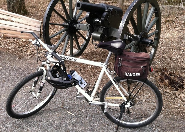 Bicycle in front of Civil War cannon in front of rocks