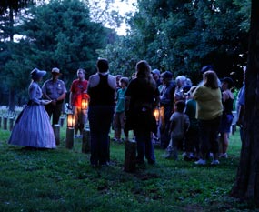 People in Stones River National cemetery carrying lanterns People in Stones River National cemetery carrying lanterns