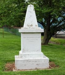 Photograph of a small obelisk monument.