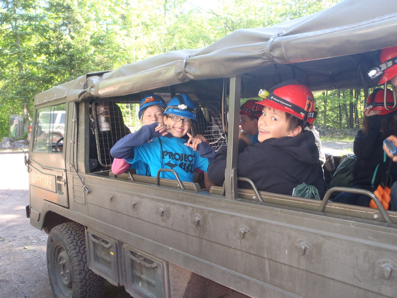 KEWE kids visit adventure mine students in a small vehicle
