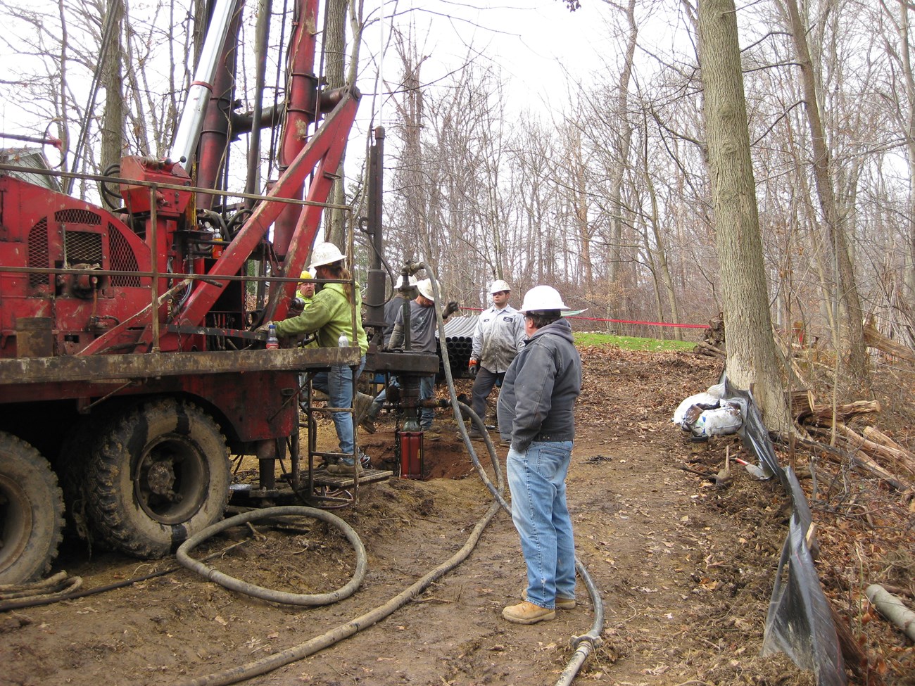 men with heavy equipment working in the woods