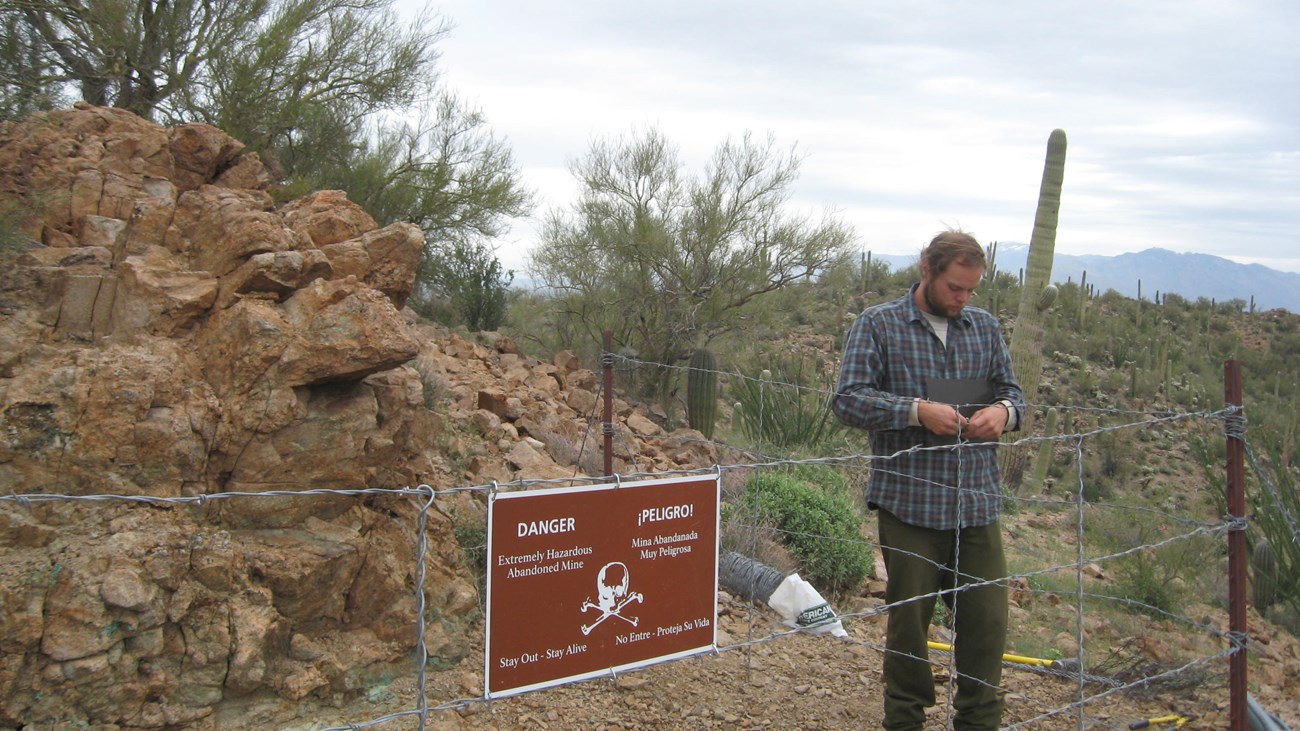 a person building closure wire fencing