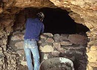 person building a rock wall mine closure