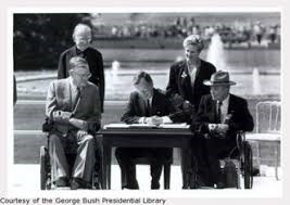 Signing of the ADA within 1990 with President and two wheelchair users.