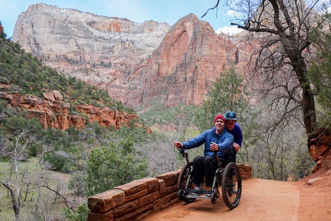Hiker using a Mountain Trike off-road wheelchair on a trail in Zion National Park Hiker using a Mountain Trike off-road wheelchair on a trail in Zion National Park