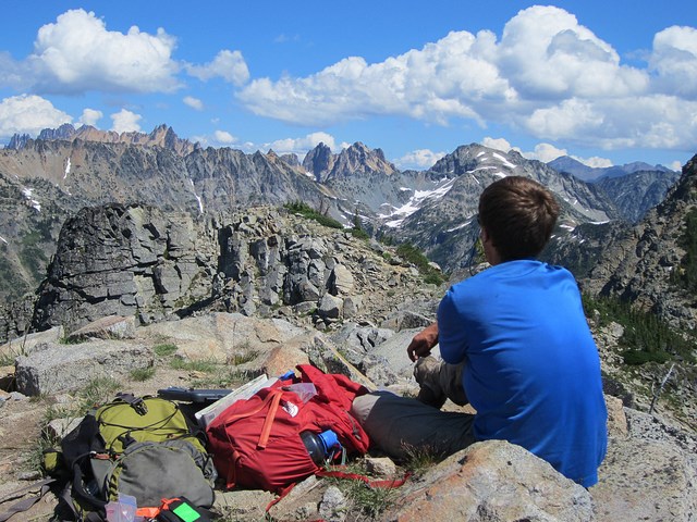 lt= Visitor enjoying a view at Stephen Mather Wilderness, North Cascades NP.