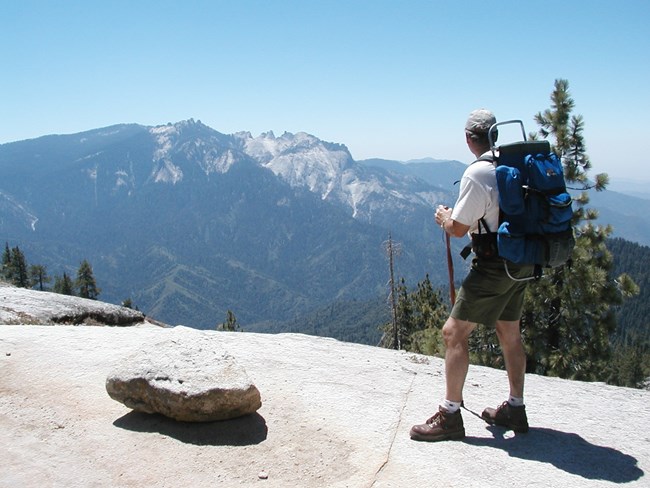 Hiker on trail to Bear Paw High Sierra Camp, Sequoia and Kings Canyon National Park, California.