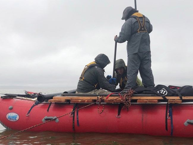 Scientists extract lake bed cores.