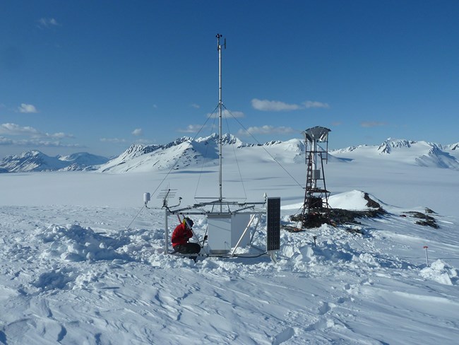 A climate station in a snowy mountain range.