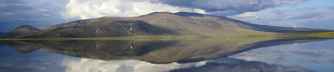 Noatak Reflections Low rolling mountains and clouds reflected in water at Noatak National Preserve.